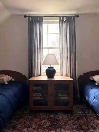 a living room with a bed furniture and a window