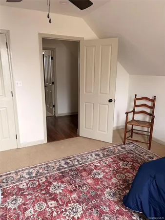 a view of a bedroom with wooden floor and closet