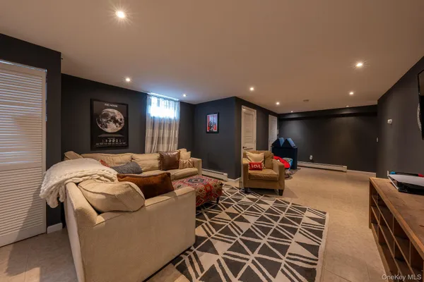 a living room with furniture gym equipment and a rug