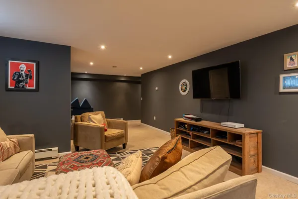 a room with furniture pool table and flat screen tv