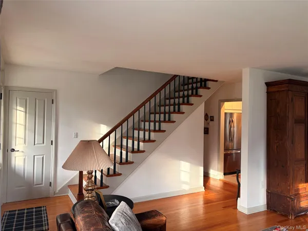 a view of entryway and hall with wooden floor