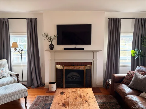 a living room with a fireplace a flat screen tv and a fireplace