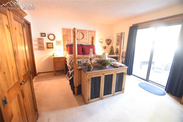 1161 Pine Ridge Road Woodland Park, CO 80863 - Photo 18 of 40 Walk-out Master Bedroom with Attached Private 3/4 Bathroom.
