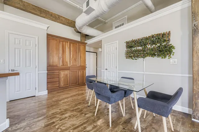 a living room with furniture a wooden floor and a window