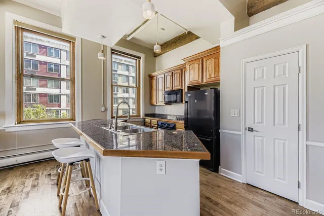 a kitchen with granite countertop a sink and a stove