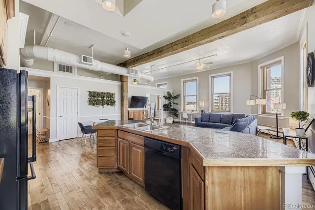 a kitchen with a table chairs sink and cabinets