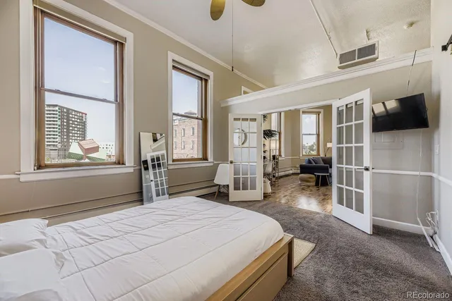 a bedroom with a bed and a window