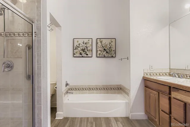 a front view of a building with cars parked