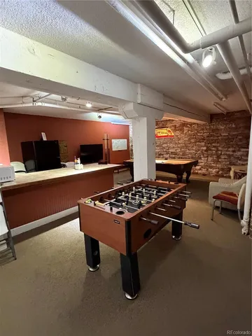 a sitting area with pool table and outdoor space