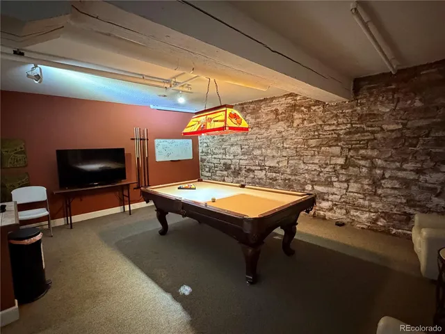 a room with pool table and flat screen tv