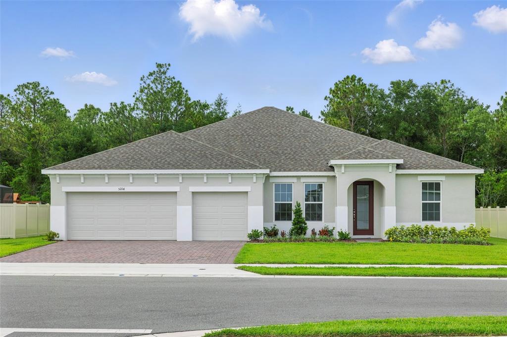 5204 Obsidian Gate Road Mount Dora, FL 32757 - Photo 1 of 1 a front view of a house with a yard and garage