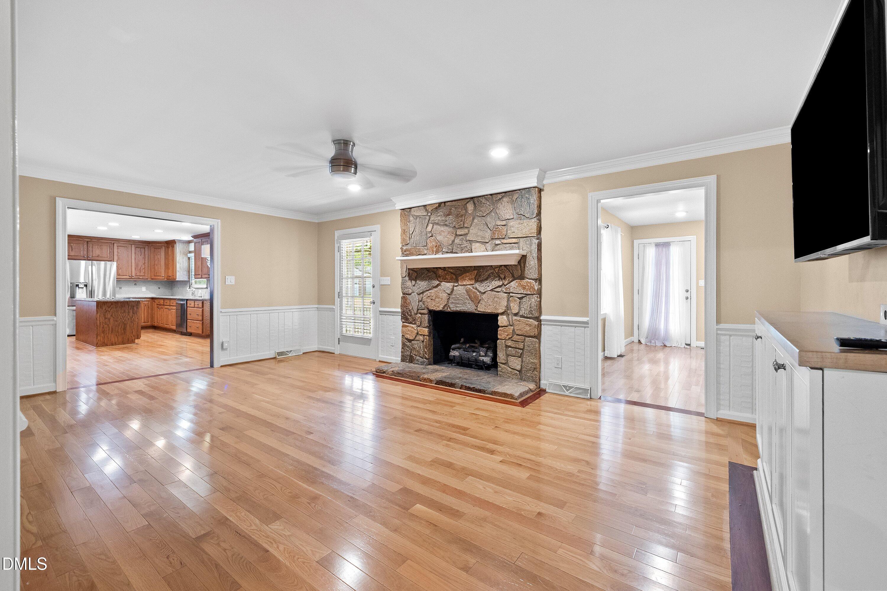 8133 Holly Forest Road Wake Forest, NC 27587 - Photo 5 of 50 a view of a livingroom with wooden floor and a fireplace
