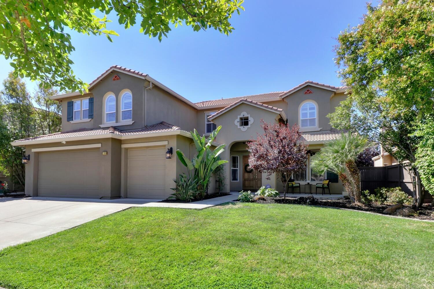 a front view of a house with a yard and garage