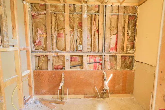 a white toilet sitting next to a shower