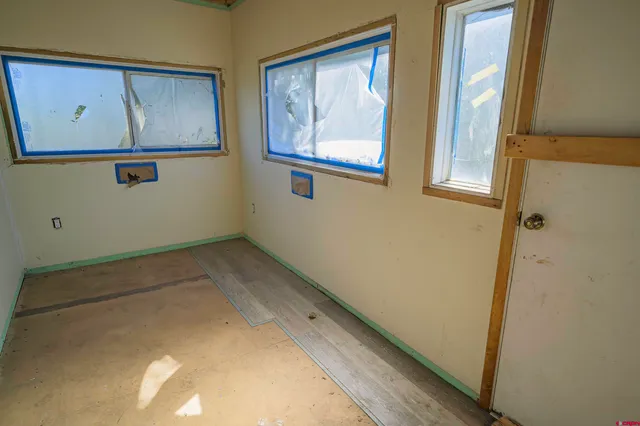 a view of a bathroom with a tub and door
