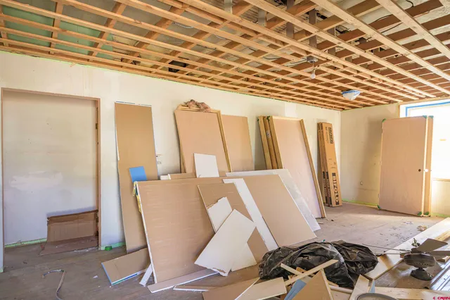 a view of a room with wooden floor and furniture
