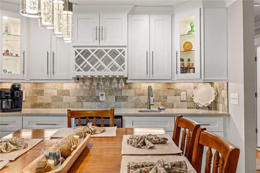 6470 Samoa Way Flowery Branch, GA 30542 - Photo 25 of 61 a kitchen with stainless steel appliances granite countertop a sink and a stove