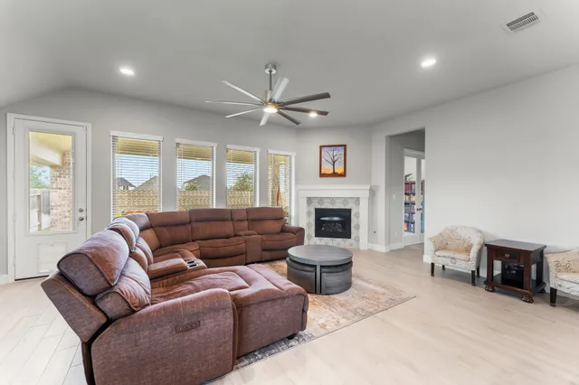 a living room with furniture and a book shelf