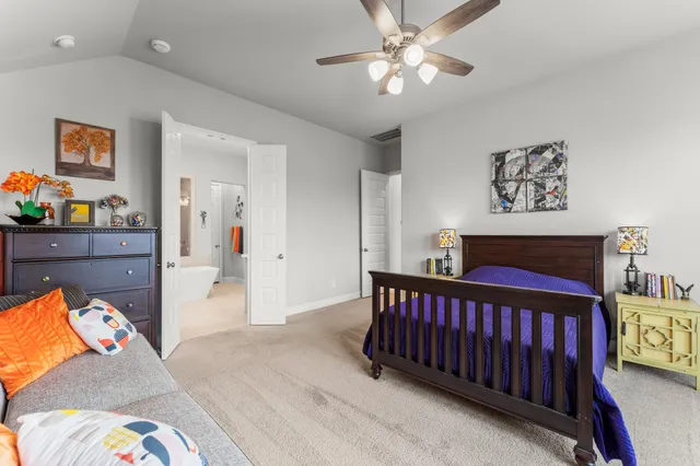 a bathroom with a tub a sink and a large mirror