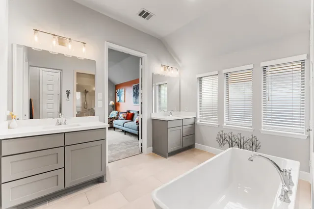 a bathroom with a bathtub and a shower