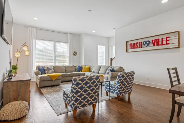 a living room with furniture and wooden floor