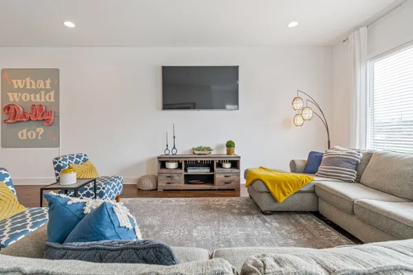a living room with furniture and a flat screen tv