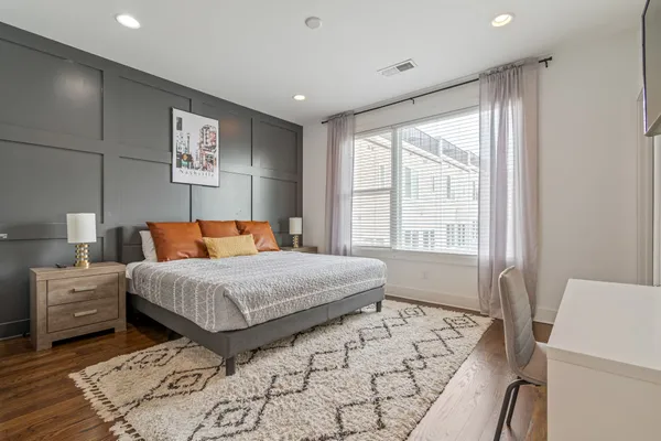 a bedroom with a large bed and a window