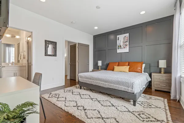 a bedroom with a large bed and a table