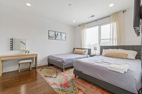 a bedroom with two beds and a dresser