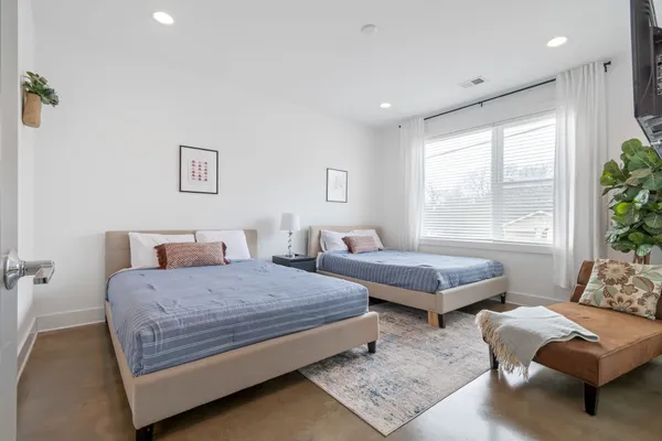 a bedroom with a bed and a couch