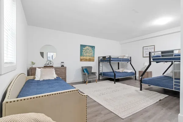 a living room with furniture a flat screen tv and gym equipment