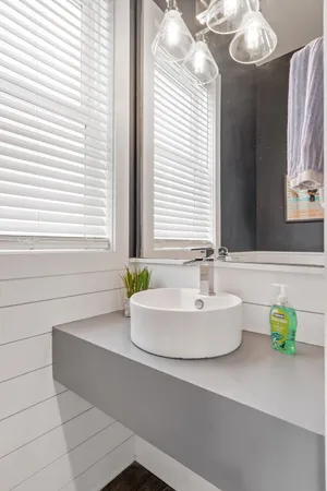 a bathroom with a bathtub a sink and a window
