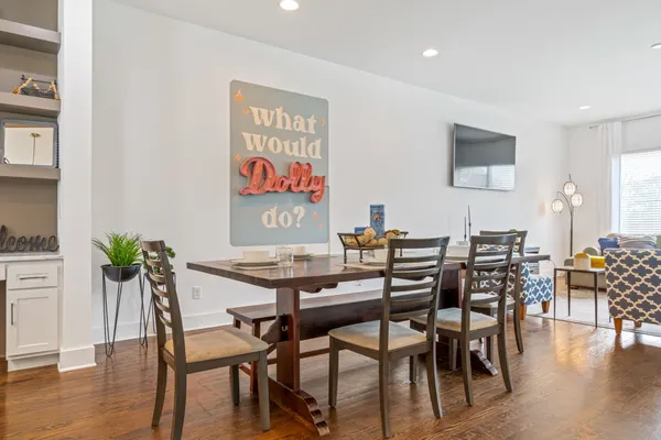 a view of a dining room with furniture wooden floor and potted plants