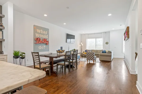 a view of a dining room with furniture and wooden floor