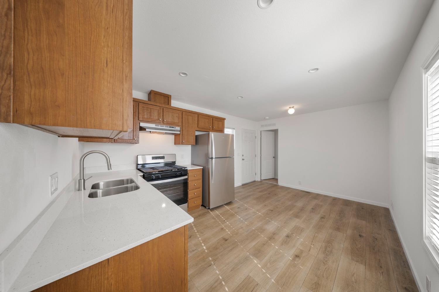 360 East Grant Line Road, Unit 19A Tracy, CA 95376 - Photo 14 of 19 a kitchen with a sink a stove and cabinets