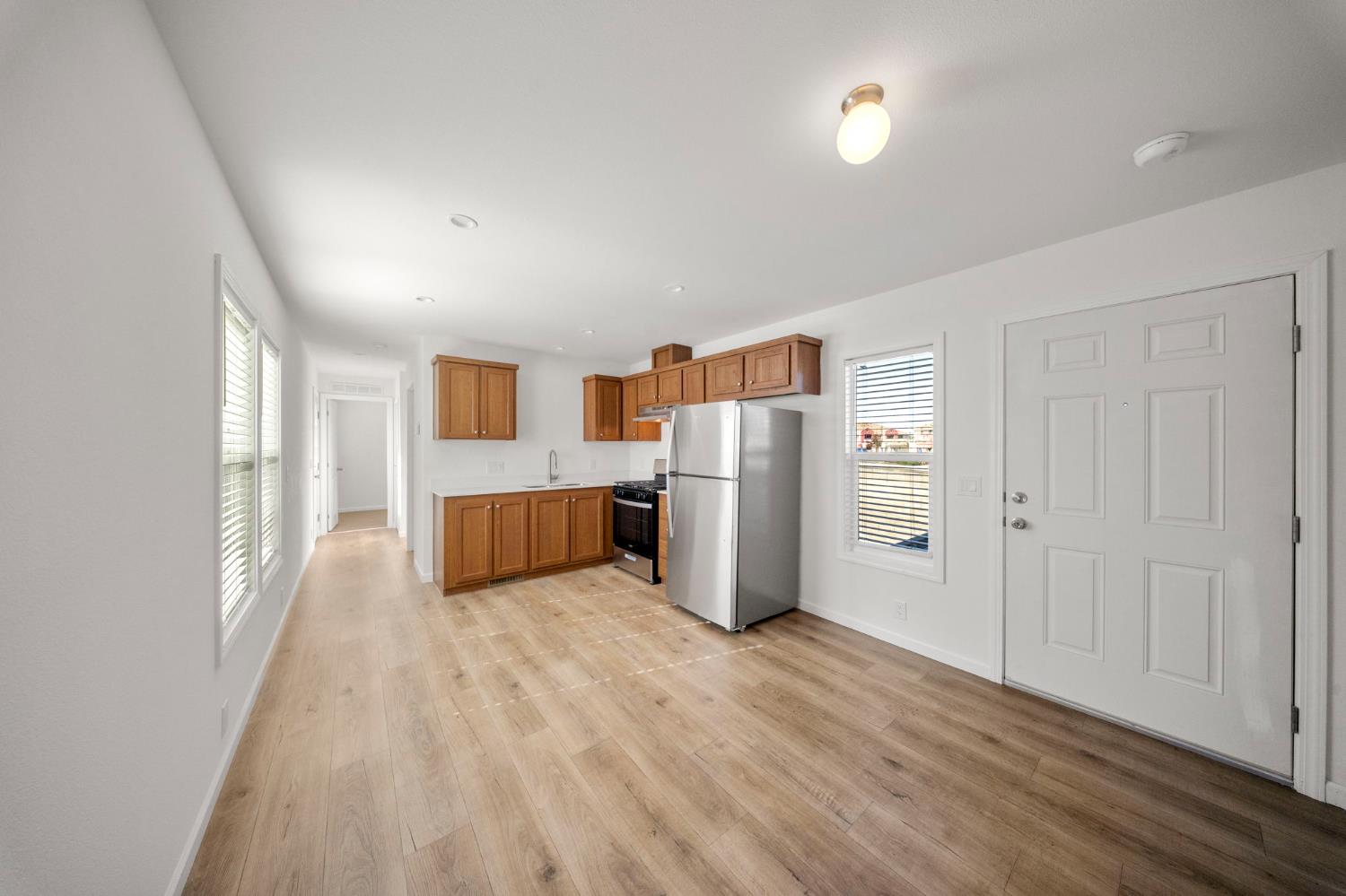 360 East Grant Line Road, Unit 19A Tracy, CA 95376 - Photo 15 of 19 a view of a kitchen with refrigerator and wooden floor