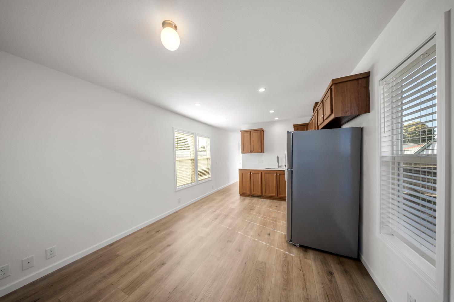 360 East Grant Line Road, Unit 19A Tracy, CA 95376 - Photo 16 of 19 a view of an empty room with a window and wooden floor