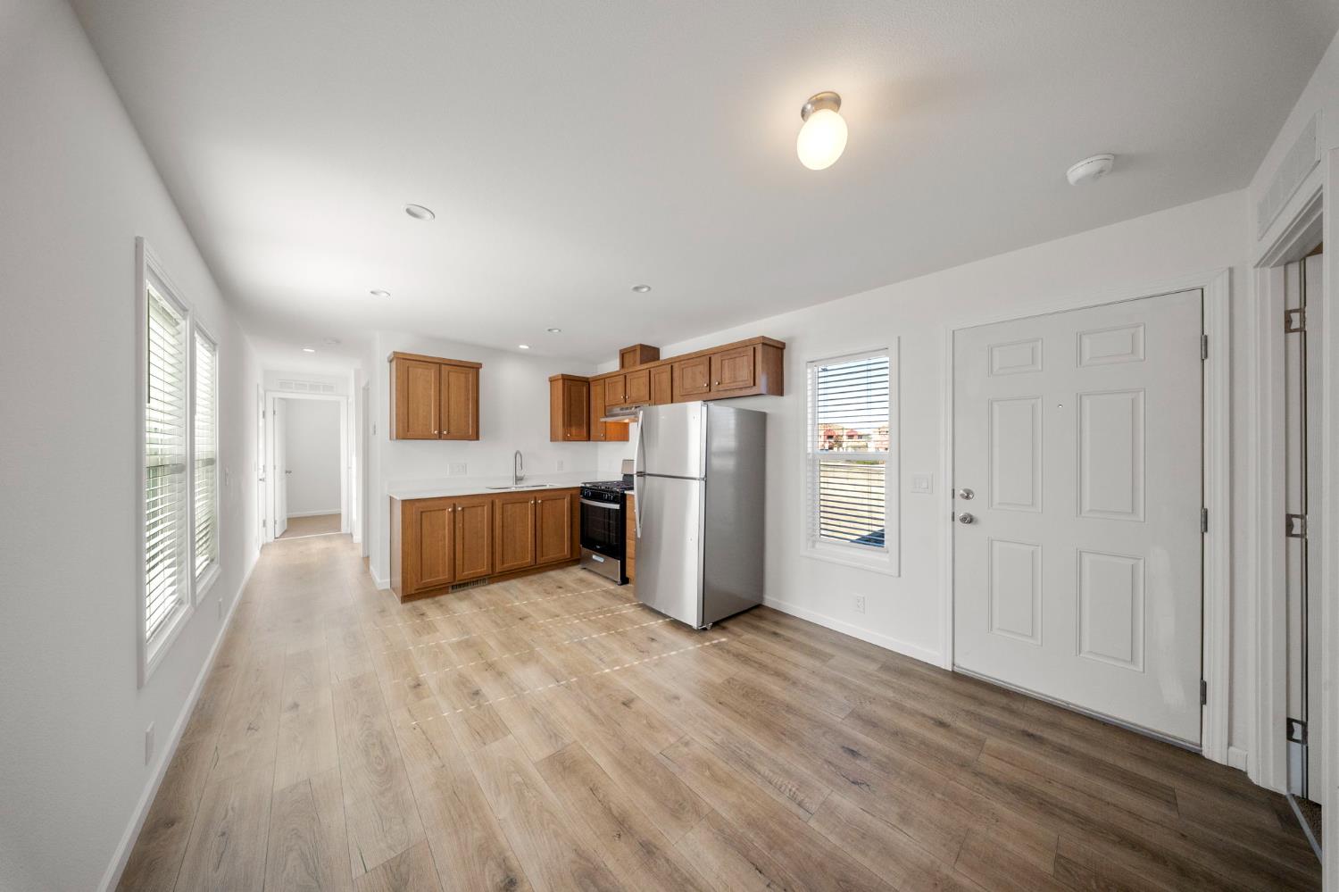 360 East Grant Line Road, Unit 19A Tracy, CA 95376 - Photo 5 of 19 a view of a kitchen with refrigerator and wooden floor