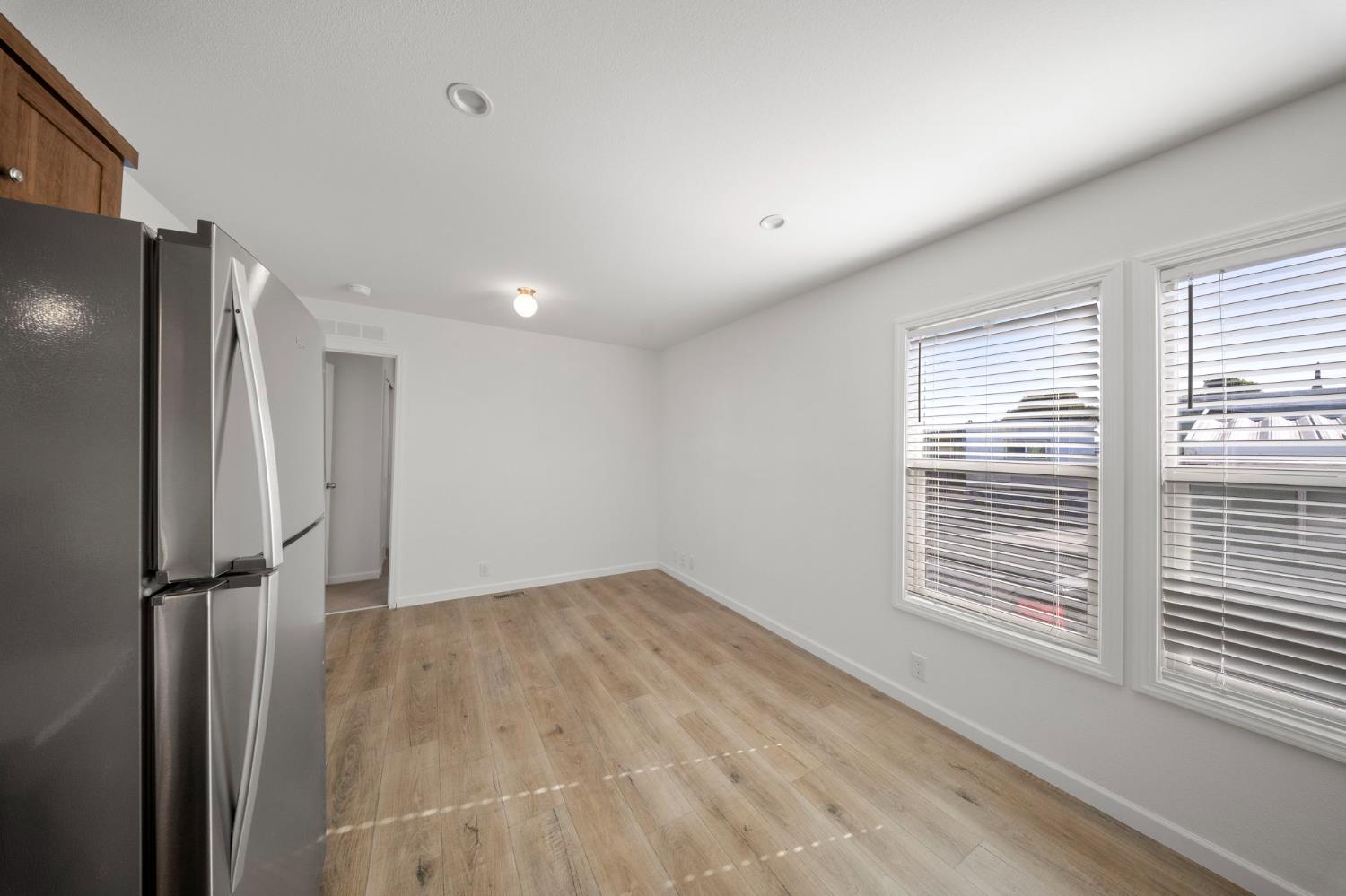 360 East Grant Line Road, Unit 19A Tracy, CA 95376 - Photo 7 of 19 a view of empty room with wooden floor and fan