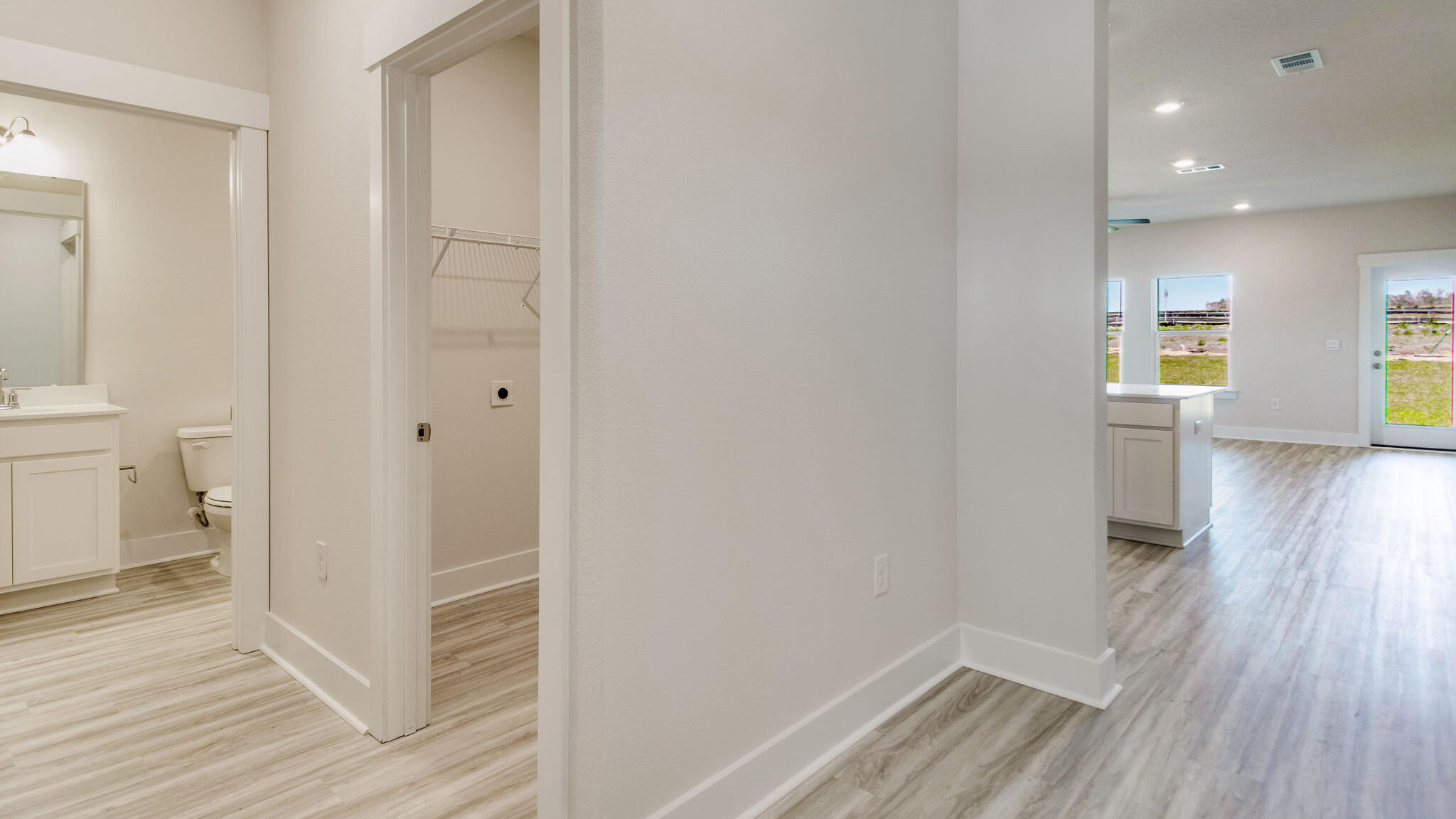 8044 Fir Tree Drive Milton, FL 32583 - Photo 12 of 32 a view of a hallway with wooden floor