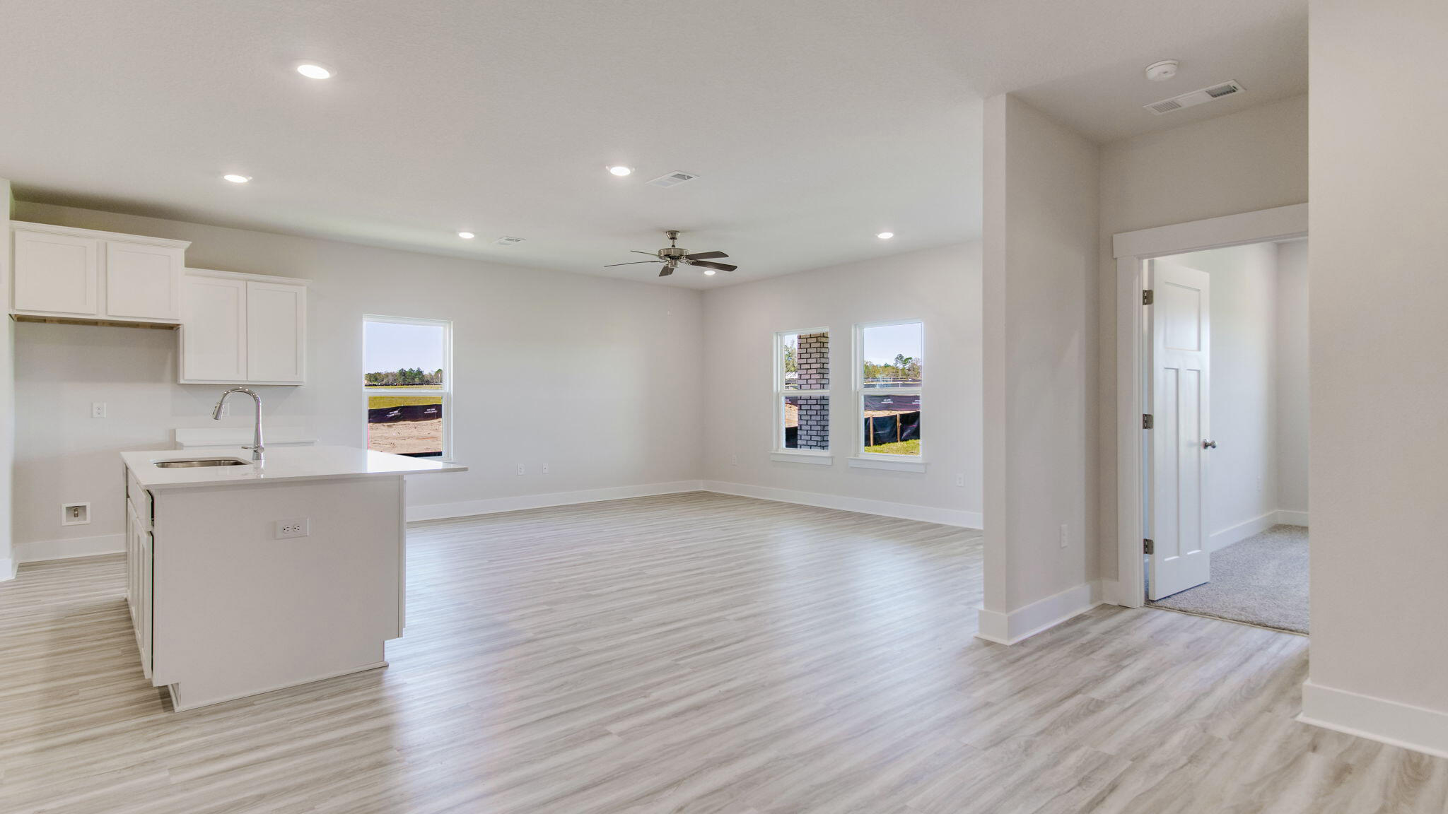 8044 Fir Tree Drive Milton, FL 32583 - Photo 13 of 32 a view of kitchen with cabinets and wooden floor