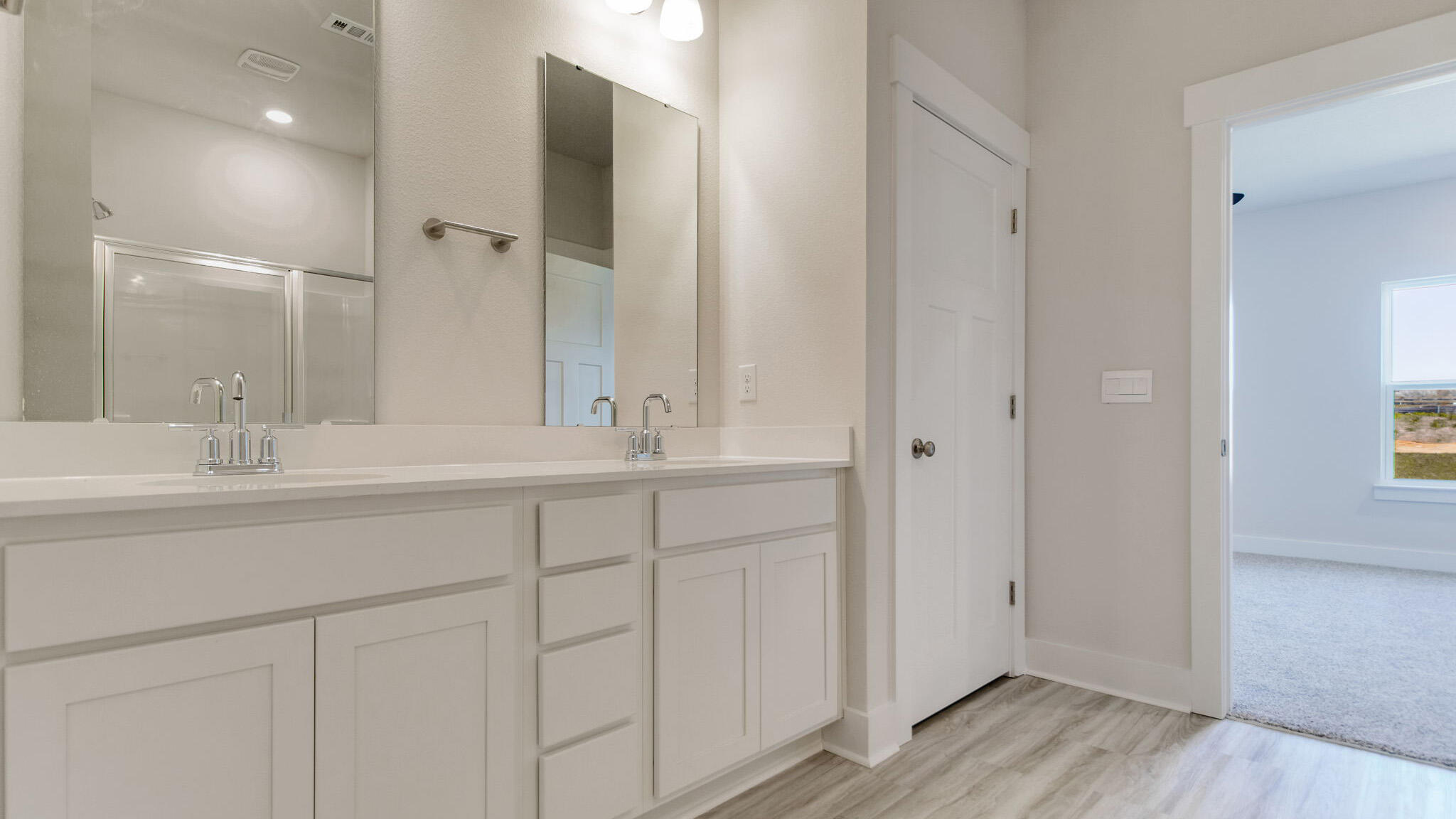 8044 Fir Tree Drive Milton, FL 32583 - Photo 18 of 32 a bathroom with double sink and a mirror