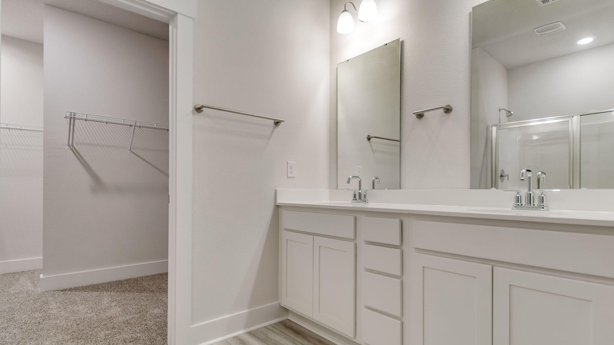 8044 Fir Tree Drive Milton, FL 32583 - Photo 22 of 32 a bathroom with a double vanity sink and mirror