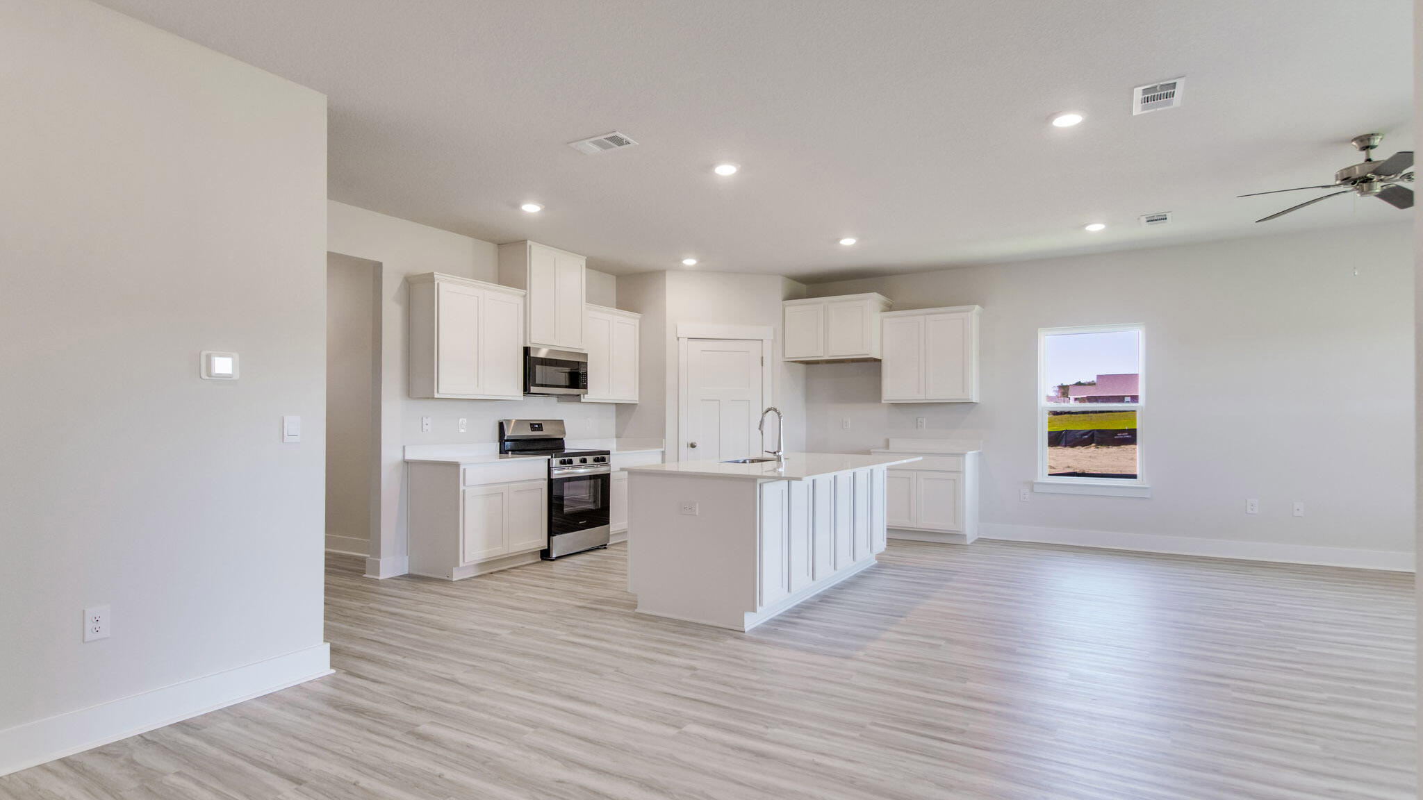 8044 Fir Tree Drive Milton, FL 32583 - Photo 6 of 32 a large kitchen with stainless steel appliances granite countertop a stove a sink and a refrigerator