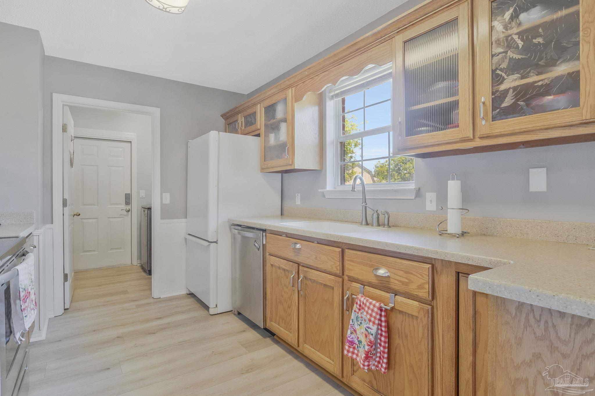 5539 Windrun Place Pace, FL 32571 - Photo 7 of 62 a kitchen with stainless steel appliances granite countertop a refrigerator and a sink
