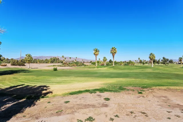 an empty room with windows and cabinet