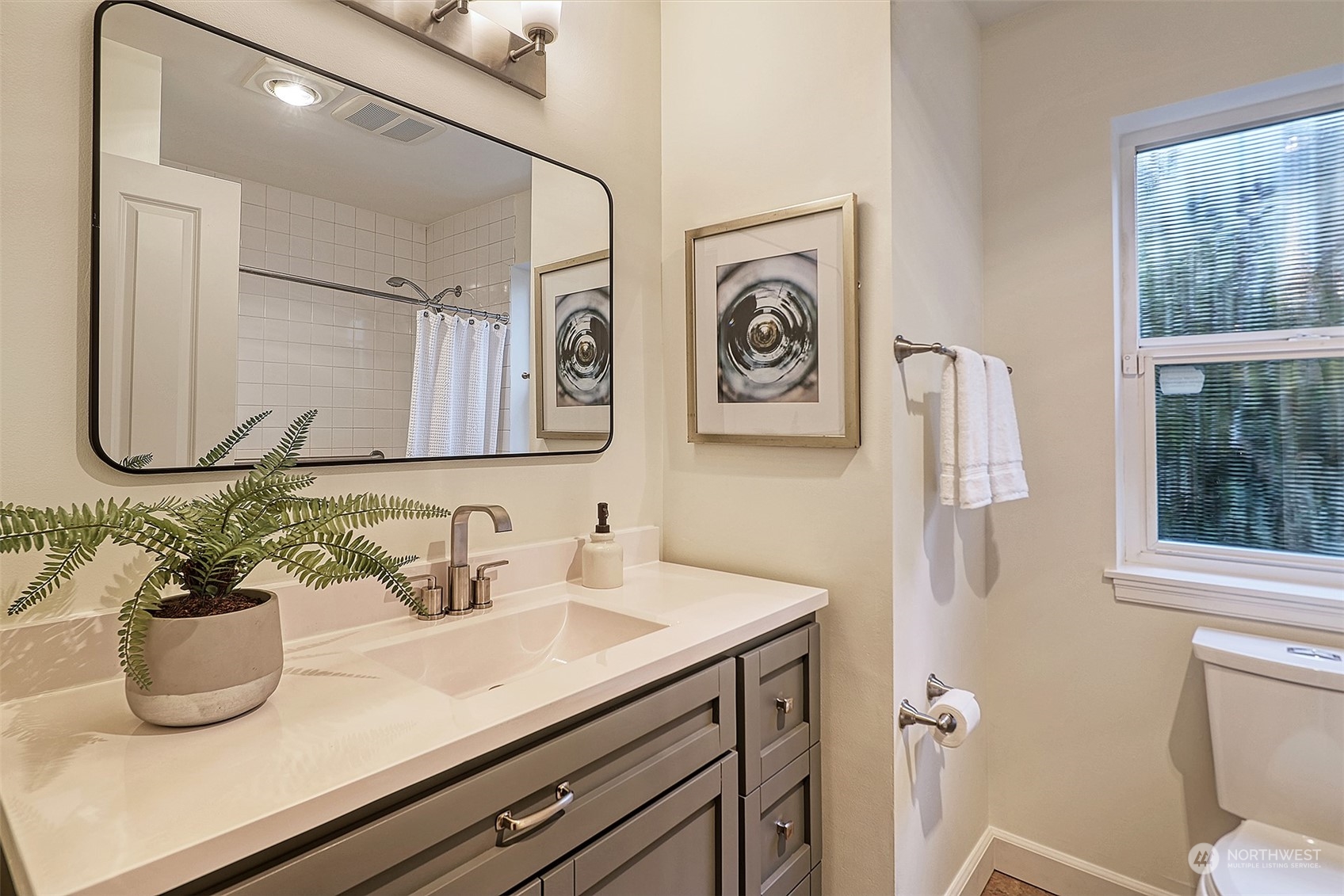 1817 20th Avenue, Unit B Seattle, WA 98122 - Photo 16 of 28 a bathroom with a sink a toilet and a mirror