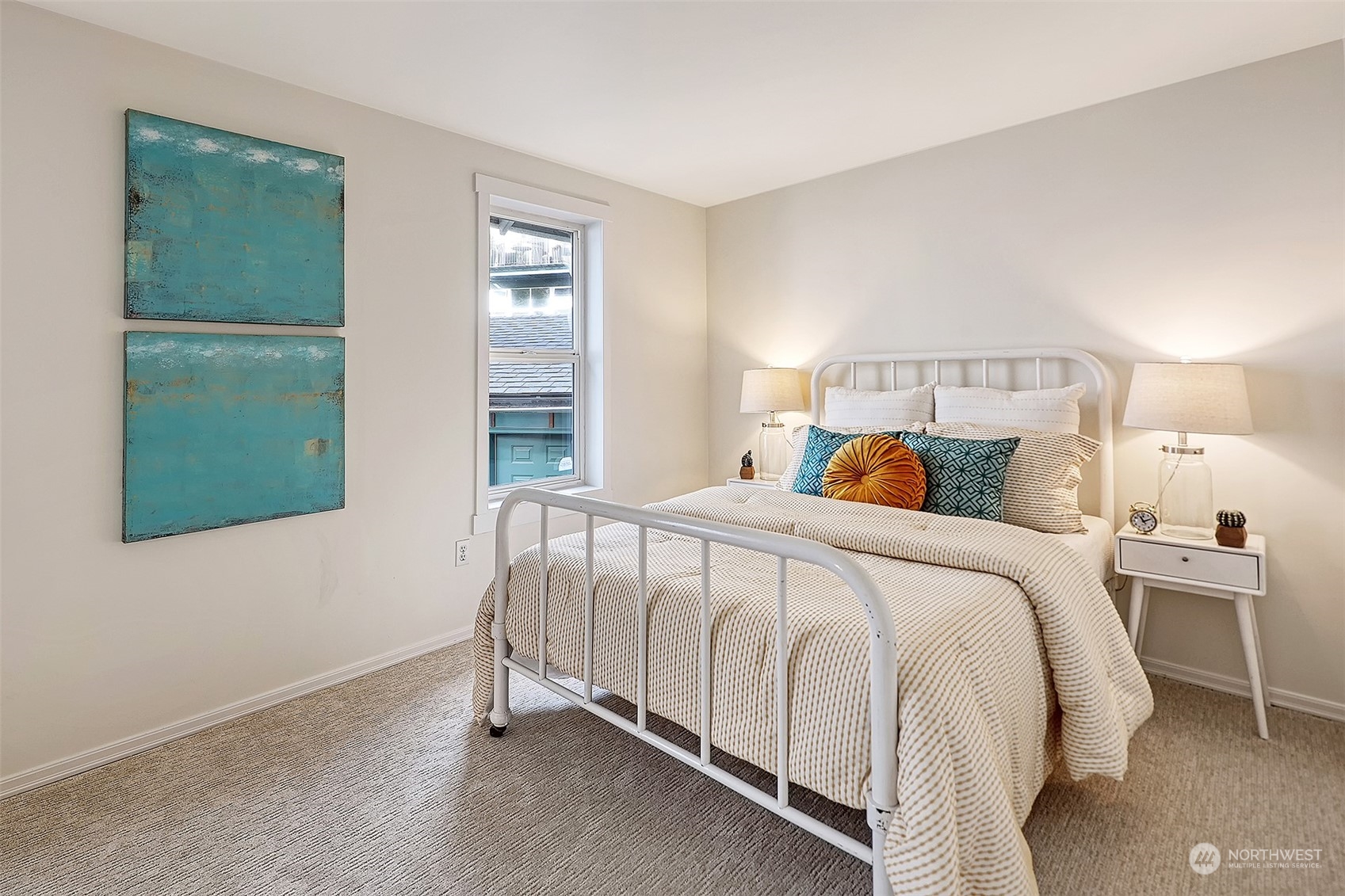 1817 20th Avenue, Unit B Seattle, WA 98122 - Photo 18 of 28 a bed sitting in a bedroom next to a window