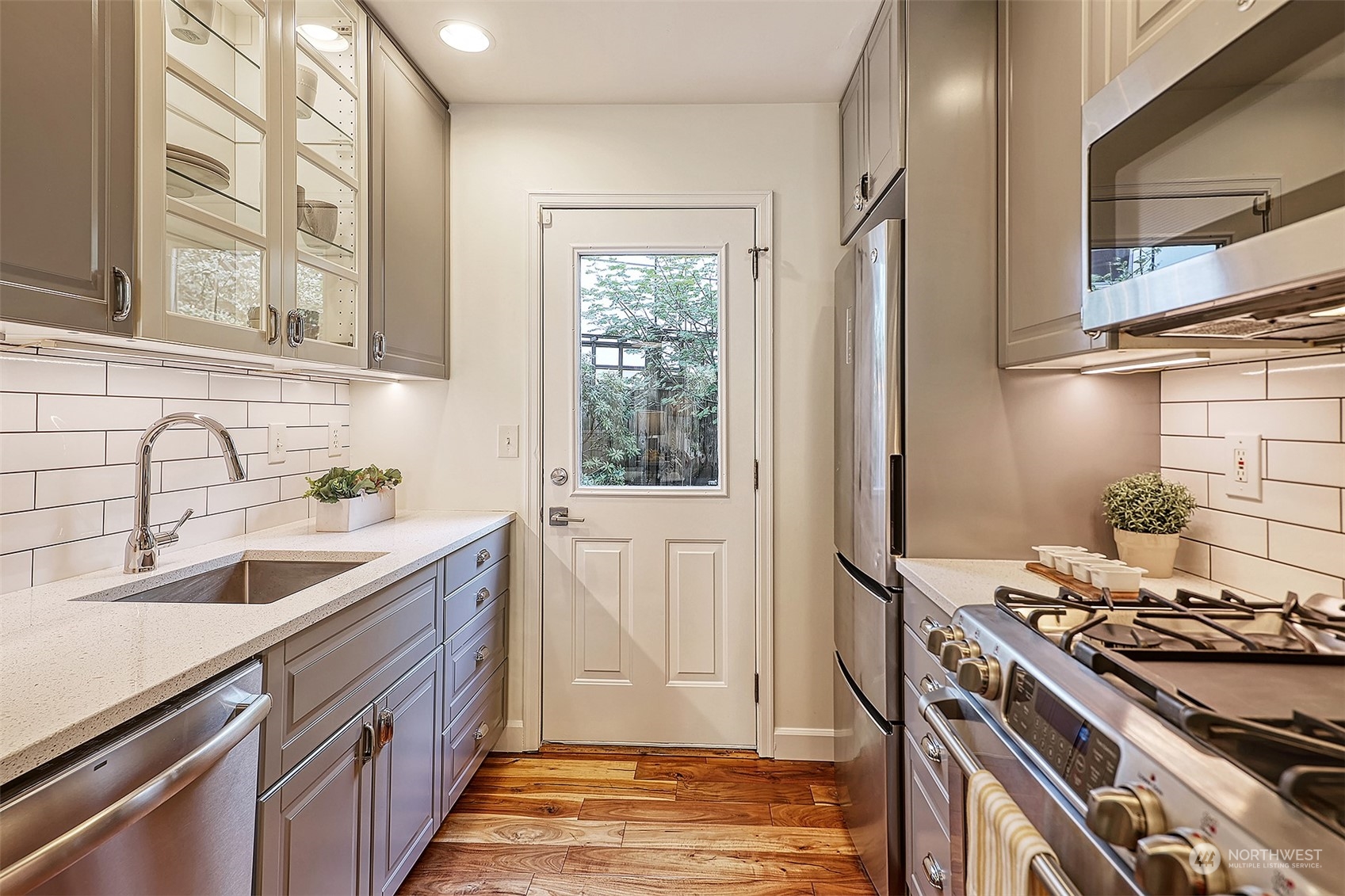 1817 20th Avenue, Unit B Seattle, WA 98122 - Photo 7 of 28 a kitchen with stainless steel appliances granite countertop a sink stove and refrigerator