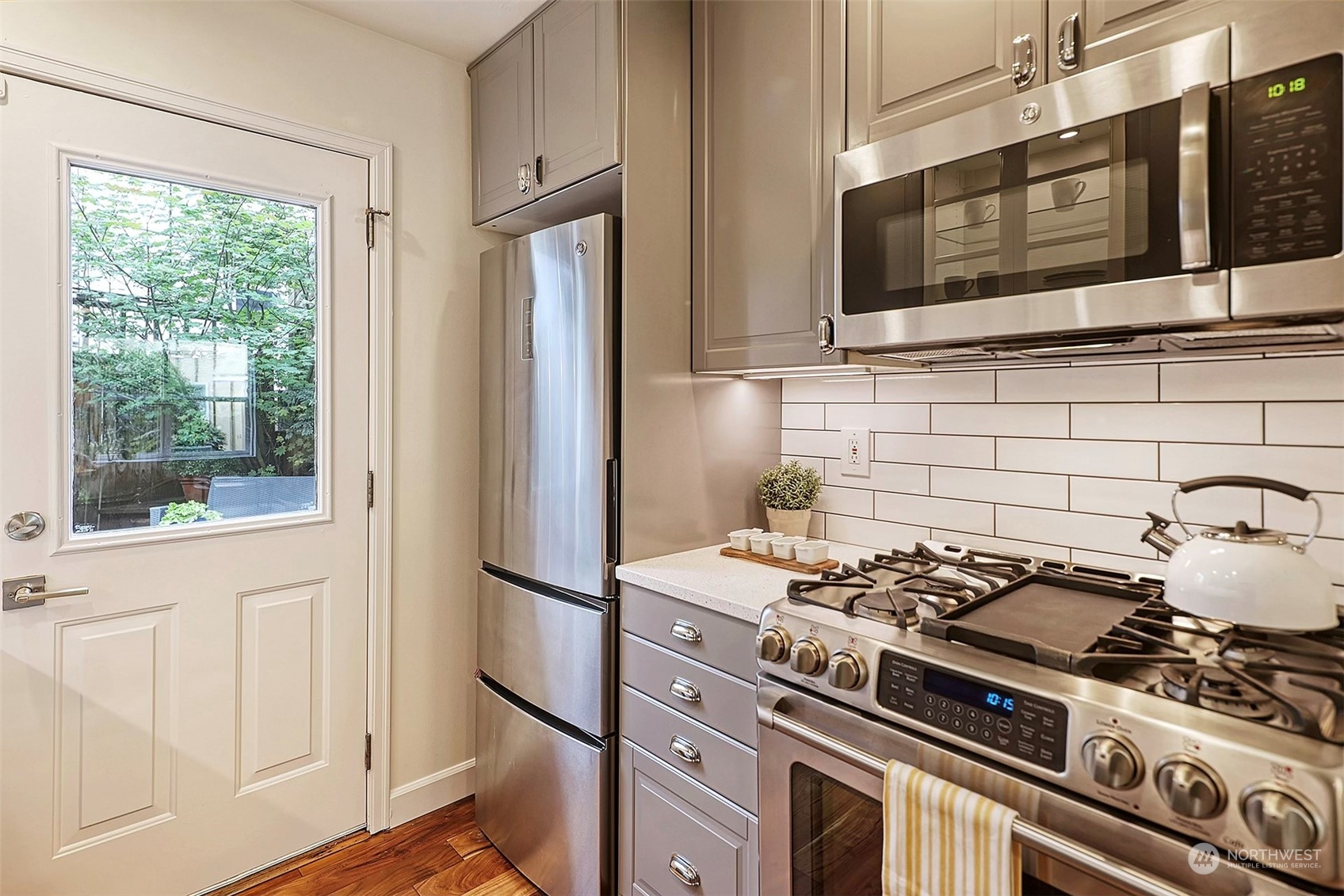 1817 20th Avenue, Unit B Seattle, WA 98122 - Photo 8 of 28 a kitchen with stainless steel appliances granite countertop a stove and a microwave